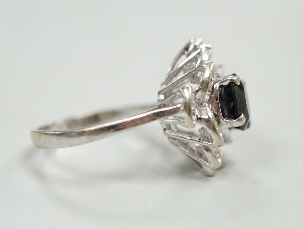 A modern 750 white metal, sapphire and diamond cluster set dress ring (two diamonds missing), size N, gross weight 5.2 grams.